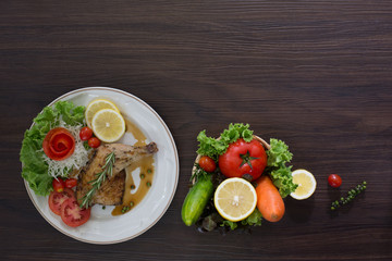 Grilled Chicken steak with black pepper In white dish and vegetables in the basket On the wooden table