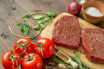 raw beef steak with ingredients for cooking