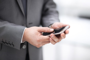 Close up of a man using mobile smart phone