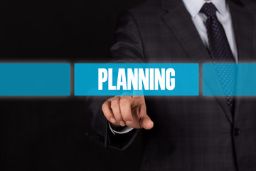 Hand pushing on a touch screen interface-PLANNING button