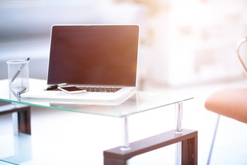 Laptop with blank screen on table.