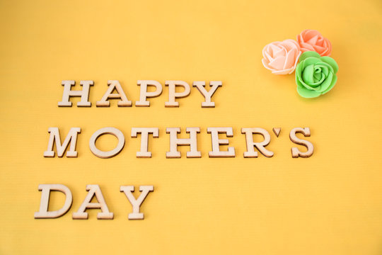 happy mother's day text, yellow background