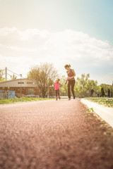 Obraz premium Caucasian mother and daughter jogging outdoors.