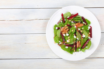 caramelized walnuts salad on white plate