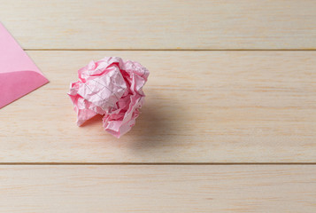crumpled paper ball on desk background