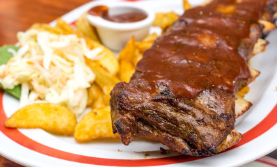 Grilled steak - Grilled meat ribs on the plate with hot sauce