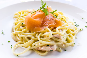 tasty pasta with salmon on a the table