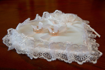Two wedding ring on a cushion in the form of heart
