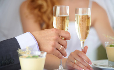 couple and holiday concept - smiling couple eating dessert at restaurant. Man and woman holding glasses of white wine