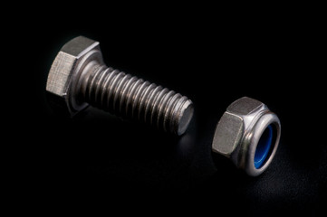 bolt and nut isolated on black background