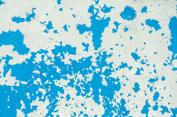 Texture of a bright blue cracked paint on an old suffered a metal surface.