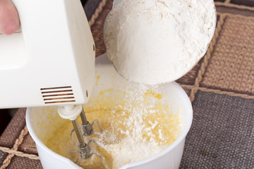 Mixing dough with flour.