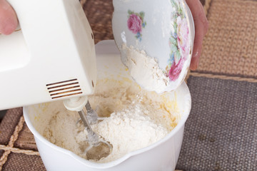 Mixing dough with flour.