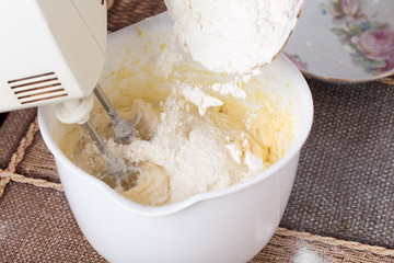 Mixing dough with flour.