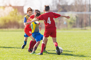 Obraz premium Kids soccer football - children players match on soccer field