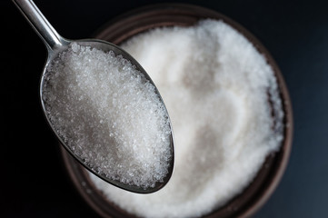 a spoon full of white sugar