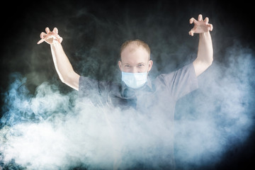 young doctor in a mask in smoke