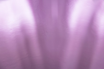 Pink glossy shiny gradient background with stripes converging in the middle of the bottom of the image