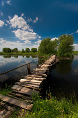 Fototapeta na wymiar wooden bridge over a pond