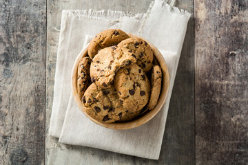Chocolate chip cookies in bowl on wooden table background. Top view
