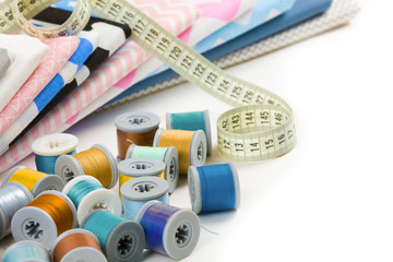 cotton fabric material, tailor measurement tape and spools of co