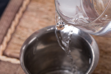 Mixing fresh water and gelatin in metal pot.