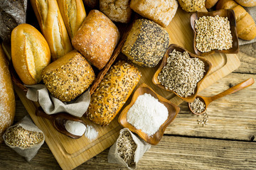 Assortment of baked bread on wooden rustic table