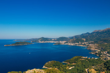 Fototapeta na wymiar Panorama of the coastline of Budva Riviera from the mountain on a sunny day. Montenegro.