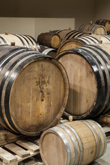 Old oak barrels in the cellar. Alcohol aging