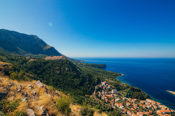 Russian village on the mountain in Montenegro over the island of Sveti Stefan.