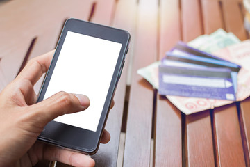 Close up of touch hands holding telephone and financial transactions copy space with sunset background.