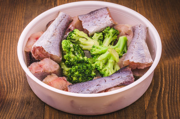 cooking of fish with broccoli in a plate/cooking of fish with broccoli close up
