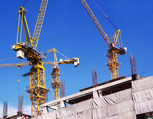 Fototapeta na wymiar Construction site with cranes on blue sky background