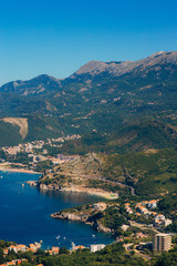 Fototapeta na wymiar Panorama of the coastline of Budva Riviera from the mountain on a sunny day. Montenegro.