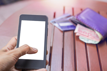 Close up of touch hands holding telephone and financial transactions copy space with sunset background.