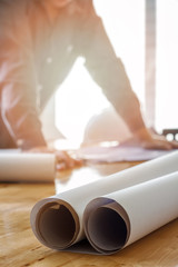 Blueprint on wooden desk with architect background