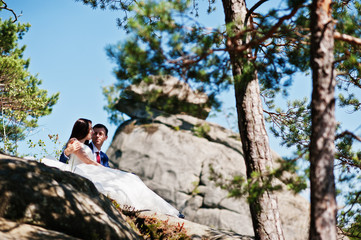 Lovely wedding couple at amazing landscapes with rock Dovbush, Carpathian mountains at Ukraine.