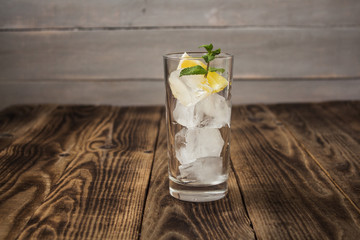clear glass with cubes of ice lemon and mint