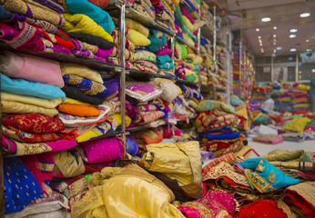 Fototapeta na wymiar Sari Shop. Indian Traditional Women's Sari clothing on Market. Buying Wedding Sari