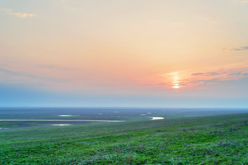 Sunrise on spring meadow