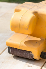 Electrical sandpaper on a wooden board with blurred background and copy space