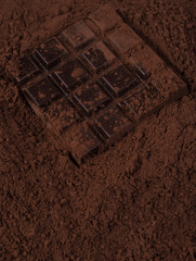 Dark chocolate bar covered in milk chocolate powder