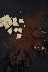 Assortment of different types of chocolate bars crashed into pieces