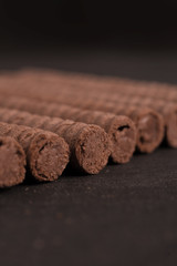 Chocolate waffle rolls in a row