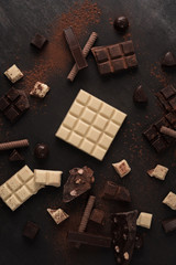 Big variety of chocolate bars crashed into pieces