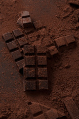 Dark chocolate bar covered in milk chocolate powder
