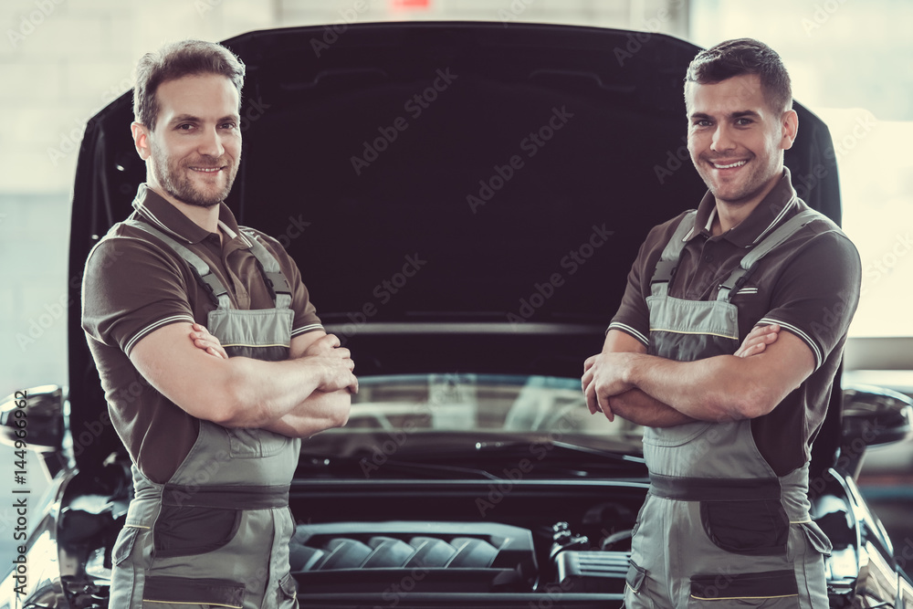 Wall mural Handsome auto service workers