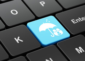 Protection concept: Family And Umbrella on computer keyboard background