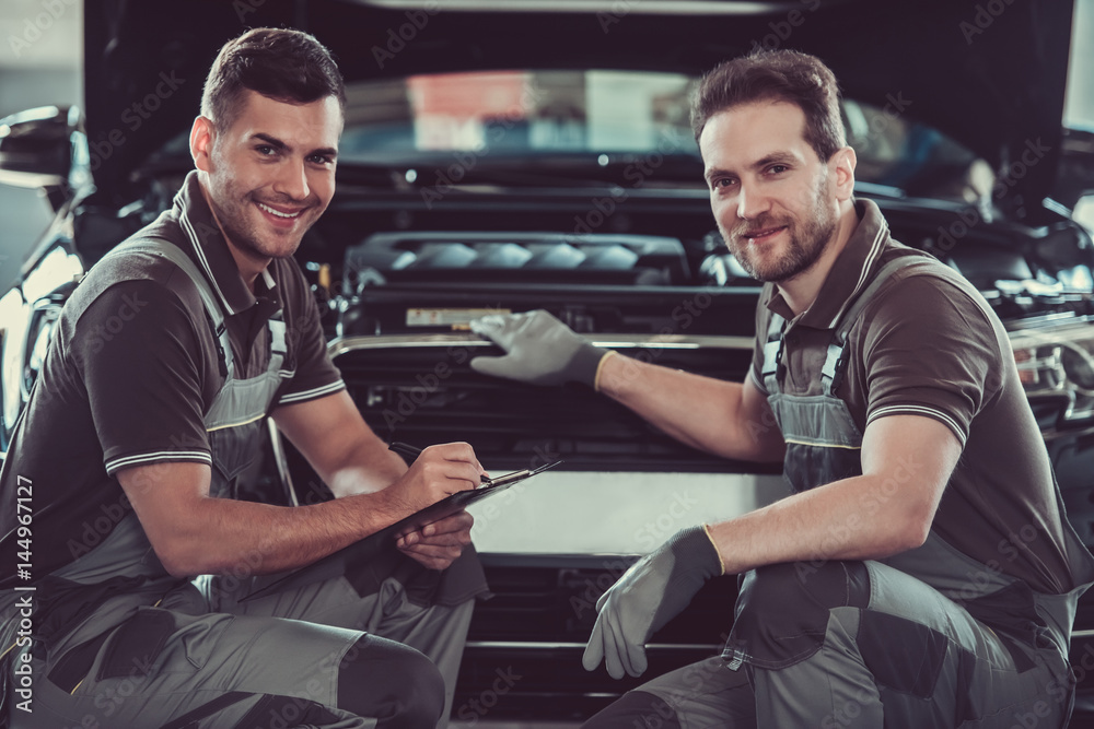 Wall mural Handsome auto service workers