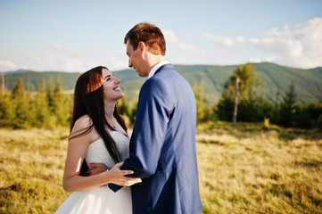 Lovely wedding couple at amazing landscapes of Carpathian mountains.